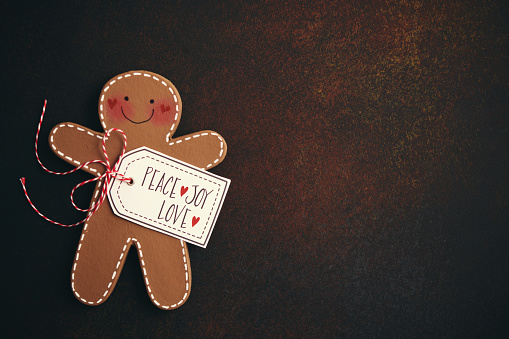Christmas Background with Handmade Gingerbread Man and Holiday Message of Peace