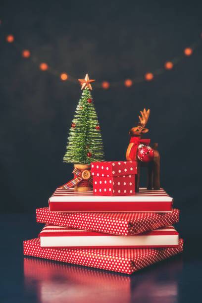 istock Modern Christmas Background with Dark Background and Christmas Tree and Deer on Vibrant Red Holiday Gifts 1344683726