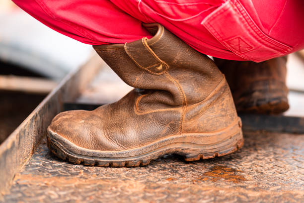 istock A workman is working during squatting on metal plate. 1344683731