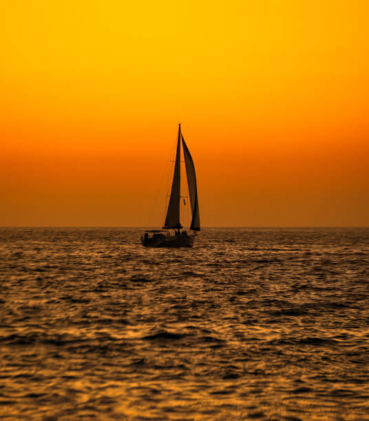 istock Sailboat Silhouette Ocean Sunset Vertical 1344685348