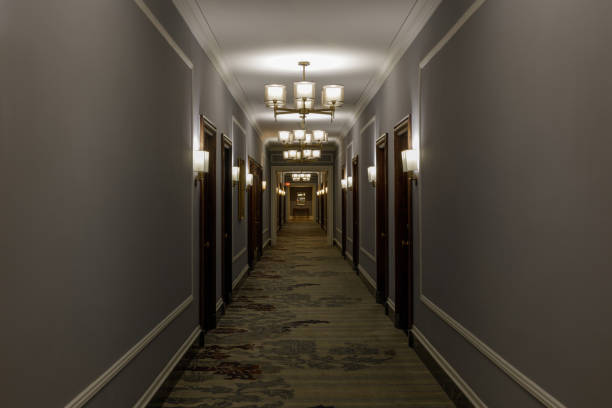 istock Empty luxurious hotel corridor lit by chandeliers 1344685537