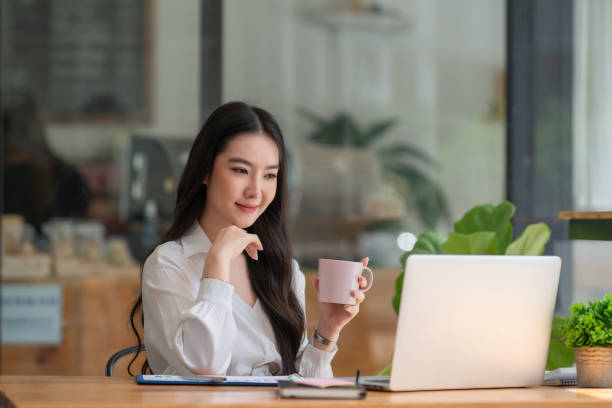 istock Businesswoman having tea or coffee in home office. 1344687514