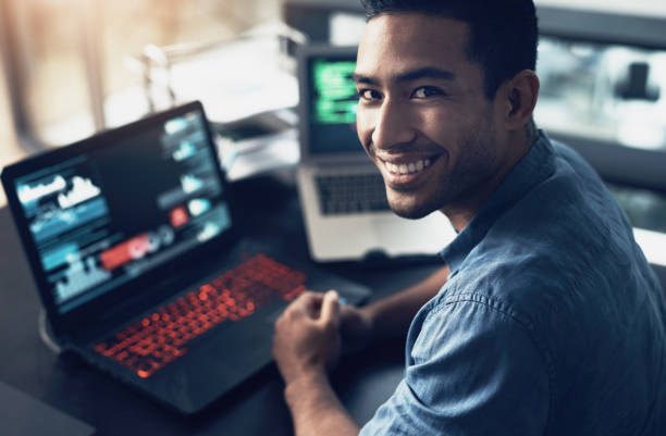 istock Portrait of a young man using a laptop in a modern office 1344688196