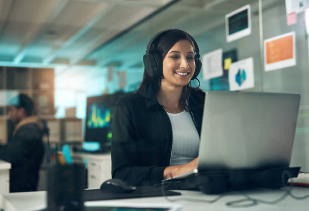 istock Shot of a young woman using a headset in a modern office 1344688362
