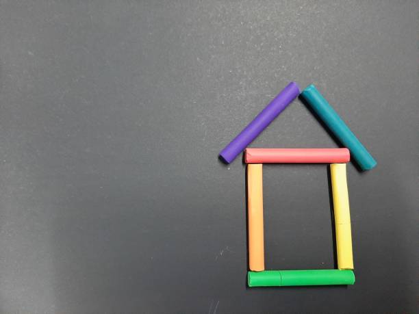 istock The house is assembled from multi-colored crayons of pastels 1344688421