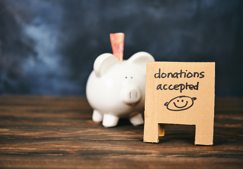 Piggy Bank with Euros and Donation Sign