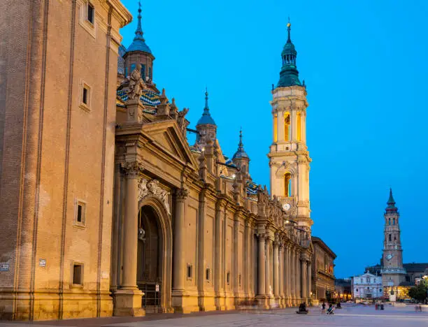 The Cathedral-Basilica of Our Lady of the Pillar and Cathedral of the Savior of Zaragoza in Zaragoza, Spain at dusk.