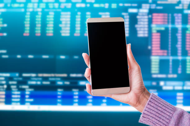 istock Saff holding mobile with pen and graph candlestick chart trade forex growth data stock market 1344692798