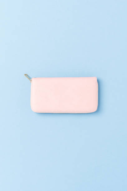 istock Pink purse on blue background. Top view 1344693098