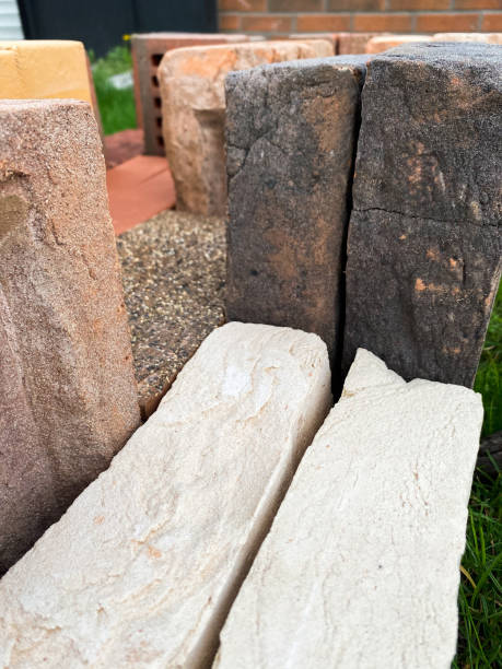 istock Different types of bricks stacked beautifully on green grass 1344693979