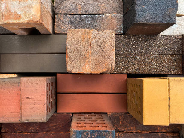 istock Different types of bricks stacked beautifully on green grass. Top view. 1344694013