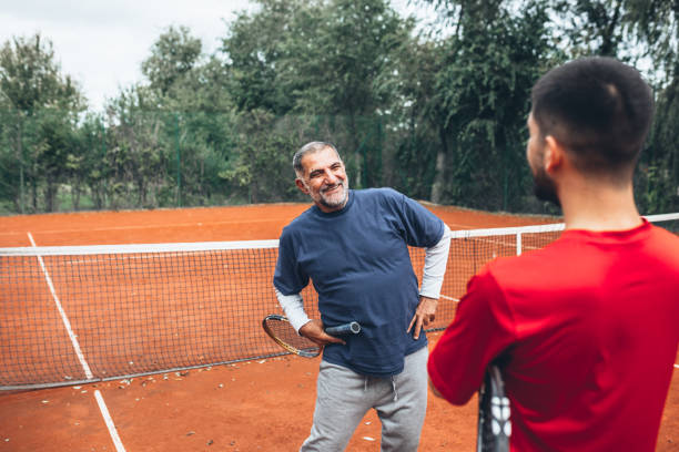 istock friends playing tennis 1344699274