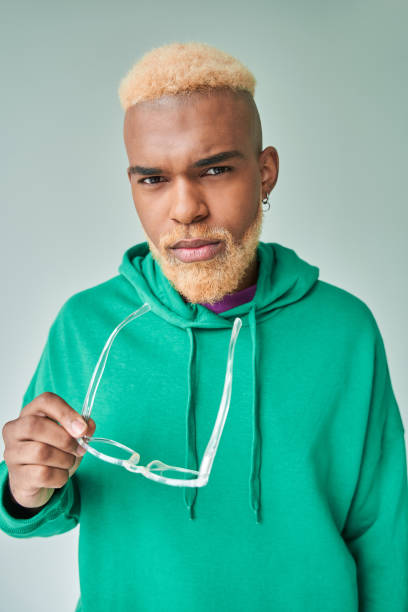 istock Man being involved in thoughts against white background while holding his glasses 1344702547