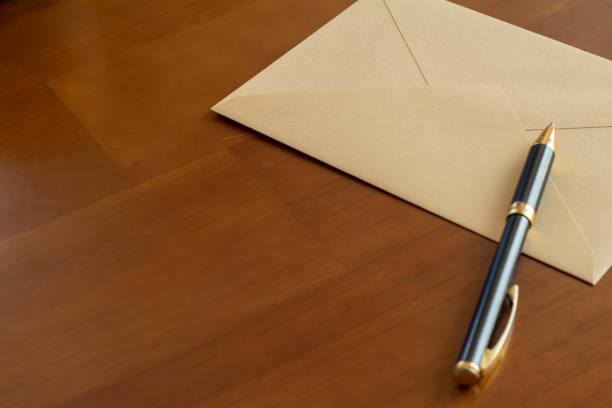 istock Envelopes and ballpoint pens placed on the table 1344703974