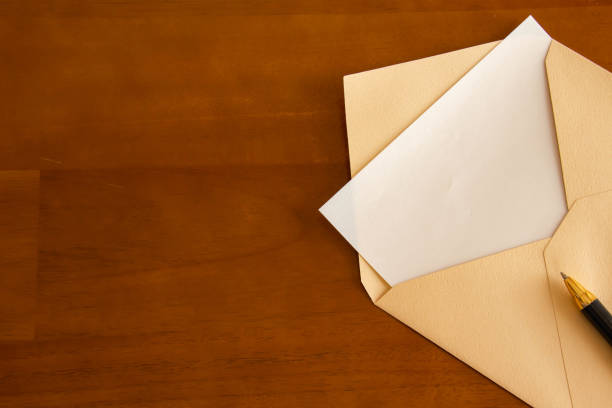 istock Envelopes and ballpoint pens placed on the table 1344704004