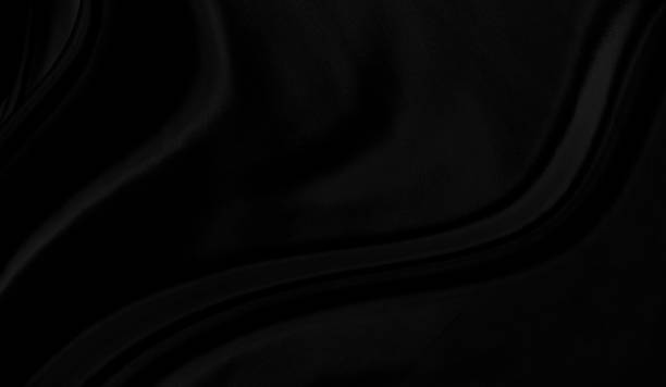 istock Black gray satin dark fabric texture luxurious shiny that is abstract silk cloth background with patterns soft waves blur beautiful. 1344705125