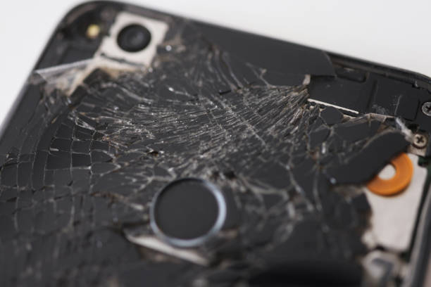 istock Closeup of black broken mobile phone in workshop 1344705445
