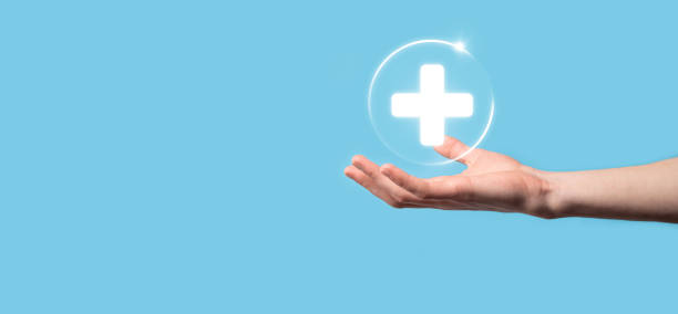 Businessman hold virtual plus medical network connection icons. Covid-19 pandemic develop people awareness and spread attention on their healthcare.