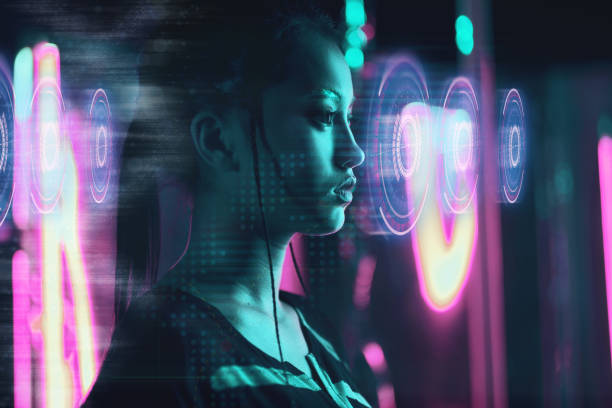 Beautiful asian woman using futuristic computer screen in neon light stock photo