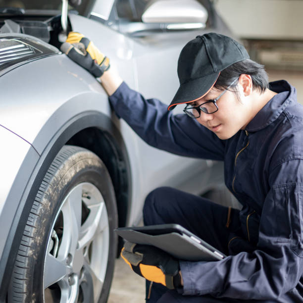 istock Asian auto mechanic checking the car wheel using tablet 1344709696