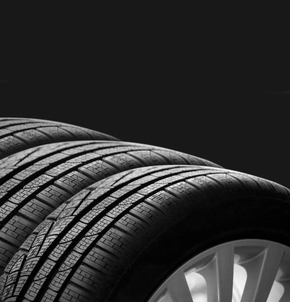 istock Car tire and rim on black background 1344709947