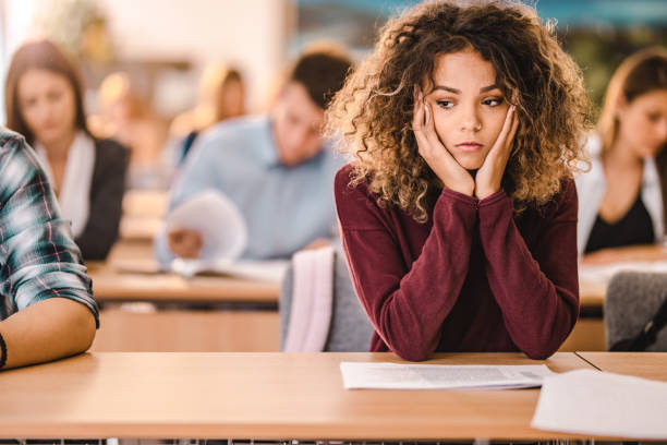 istock Worried female student on a class in the classroom. 1344710018