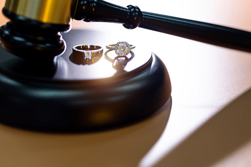 Wedding rings with gavel on the table.