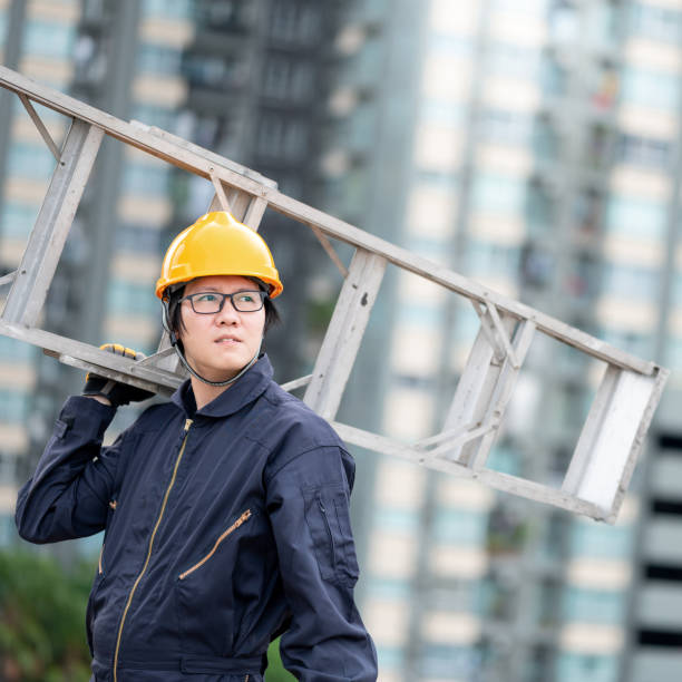 istock Maintenance worker man carrying aluminium ladder 1344713879