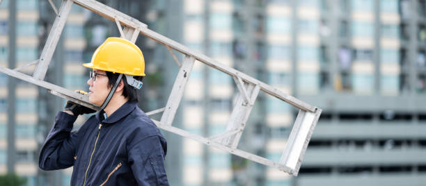 istock Maintenance worker man carrying aluminium ladder 1344713995