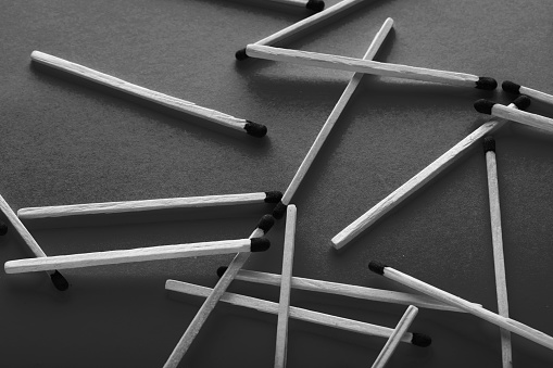 Matches on a paper background, an abstraction about teamwork and modern relationships.