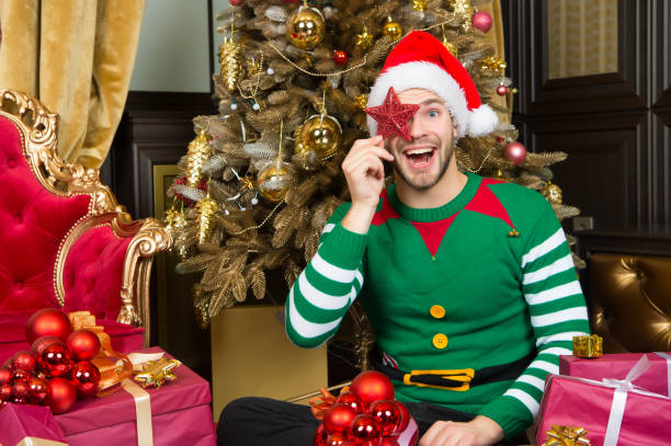 Man santa cover smiling face with star decoration