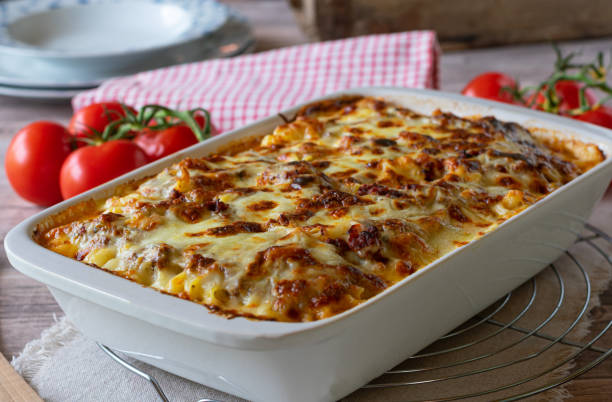 Pasta casserole with bolognese and bechamel sauce and mozzarella cheese topping stock photo
