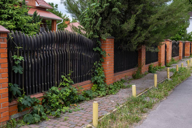 istock Beautiful decorative modern wooden fence with brick columns. 1344719099