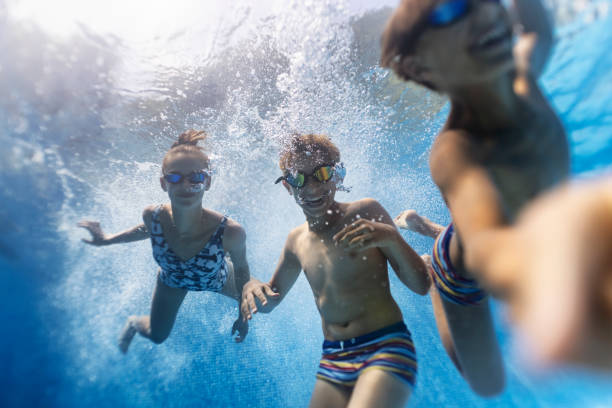 istock Teenager playing underwater in pool 1344719165