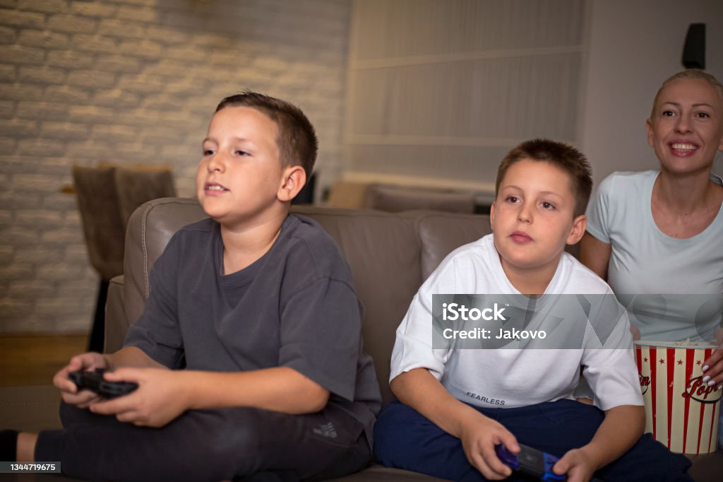 Mother and son playing nintendo games at home 10-11 Years Stock Photo