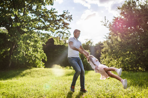 istock Happy father and daughter spinning around at sunset 1344719808