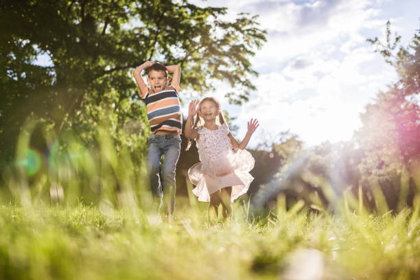 istock Beautiful children jumping in nature 1344720842