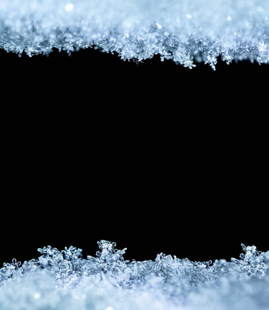 istock Natural snow texture with snowflakes close-up, isolated on black background with space for text in the center. Template for holiday gift cards. Macro texture of snow. 1344720872