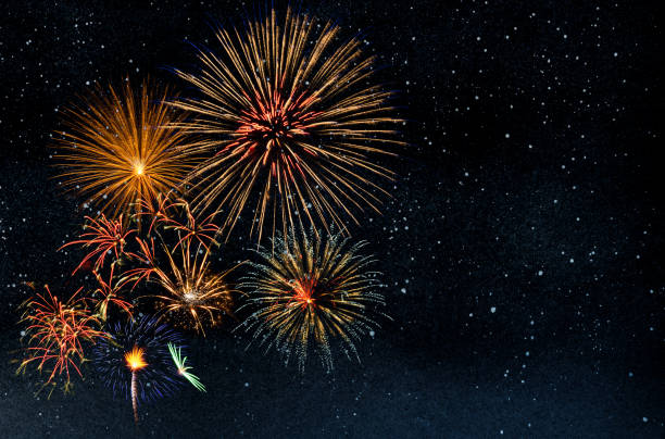 istock Fireworks on starry night sky background with copy space 1344721262