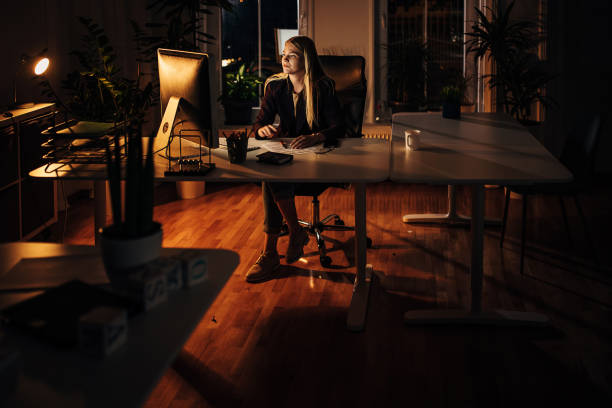 istock Business woman working at night in office 1344721361
