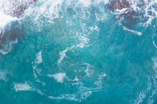 istock Aerial view of waves splashing on beach 1344723096
