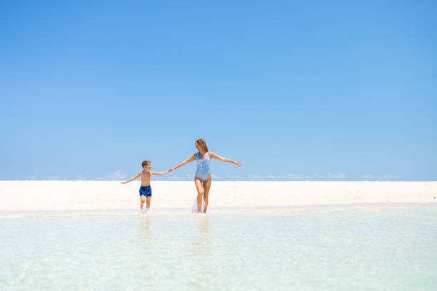 istock Happy mother and son running at the beach 1344723872