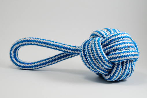 toy for dog made of durable cotton rope on a neutral background