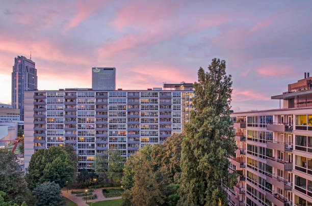Rotterdam, The Netherlands, October 3, 2021: spectacular sky at sunset over two residential buildings and park in the Lijnbaan area from the 1960's