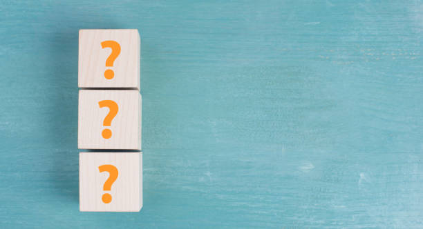 istock Three wooden cubes with question marks in orange color 1344724434