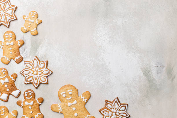 istock Christmas composition with gingerbread man cookies on light wooden background 1344724449