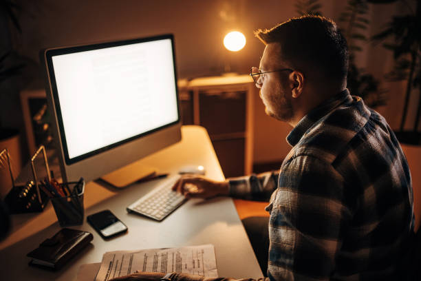istock Young businessman working at night in office 1344725663