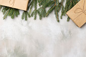 istock Table with Christmas composition with gift, decorations, fir tree branches on wooden background. Flat lay, top view 1344726679