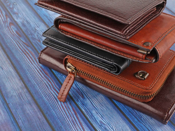 istock New leather multicolored wallets on blue wooden background 1344726739