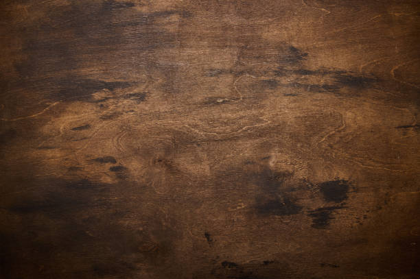 istock Dark brown and yellow textural wooden board background 1344727160